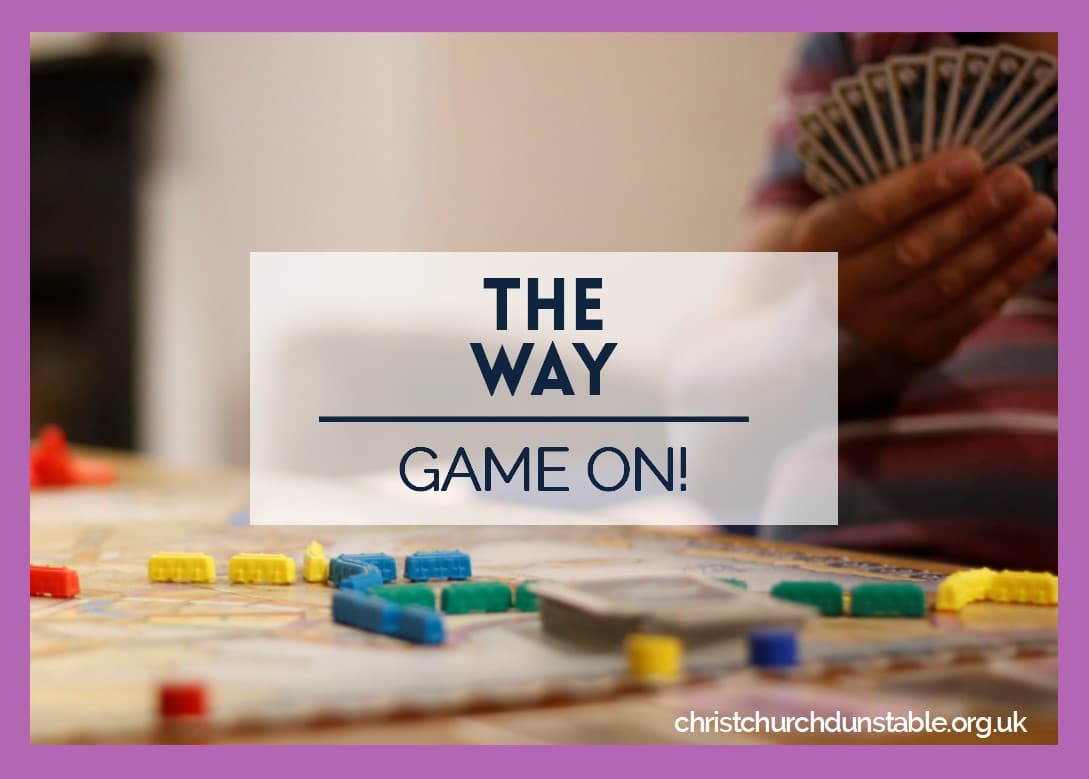 People enjoying board games at The Way Coffee House with coffee and snacks on the table